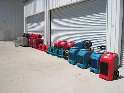 Air movers and dehumidifiers staged outside a Venice garage