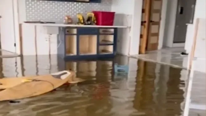 Floodwater standing in a kitchen after heavy rain in Sarasota County