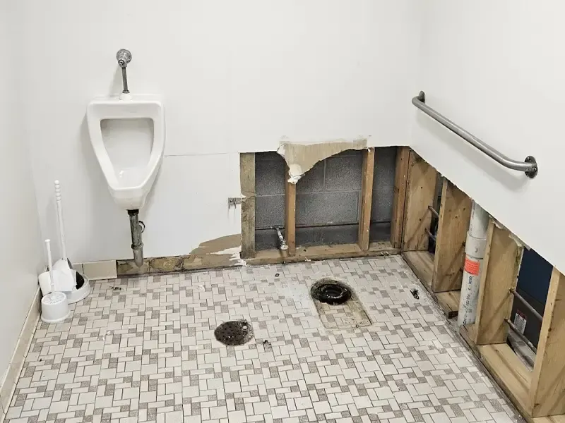 Restroom opened up for sewage backup cleanup in a Venice, FL building