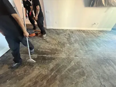 Restoration techs running an extraction wand across a wet floor in a Venice, FL home